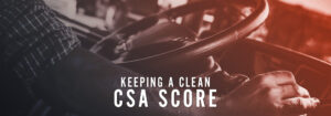 A truck driver steers their semi truck with the words "Keeping a Clean CSA Score" at the bottom.