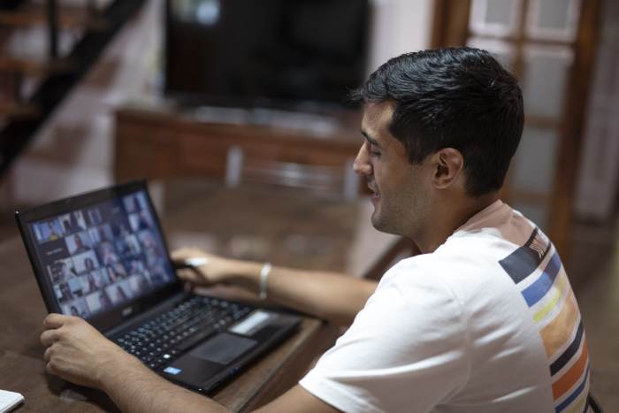 A person watches a large trucking webinar on their laptop.